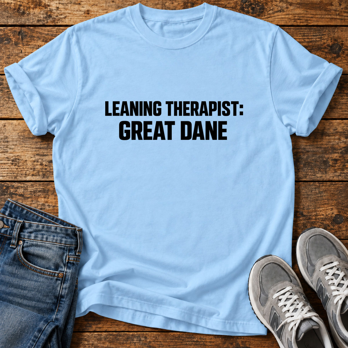 Leaning Therapist Great Dane graphic T-shirt in Light Blue, shown on a flat-lay shirt mockup