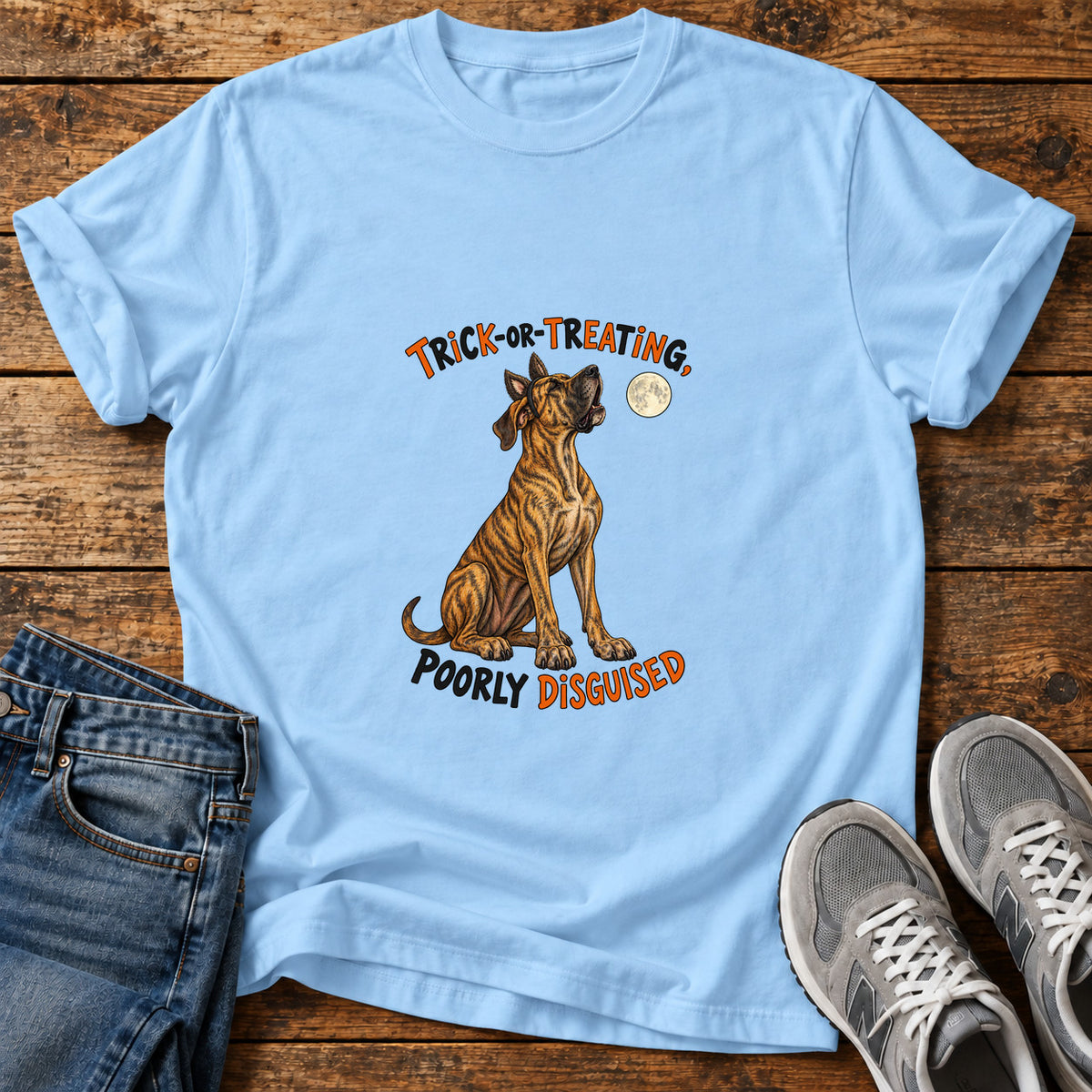 Trick-or-Treating Dog Great Dane graphic T-shirt in Light Blue, shown on a flat-lay shirt mockup