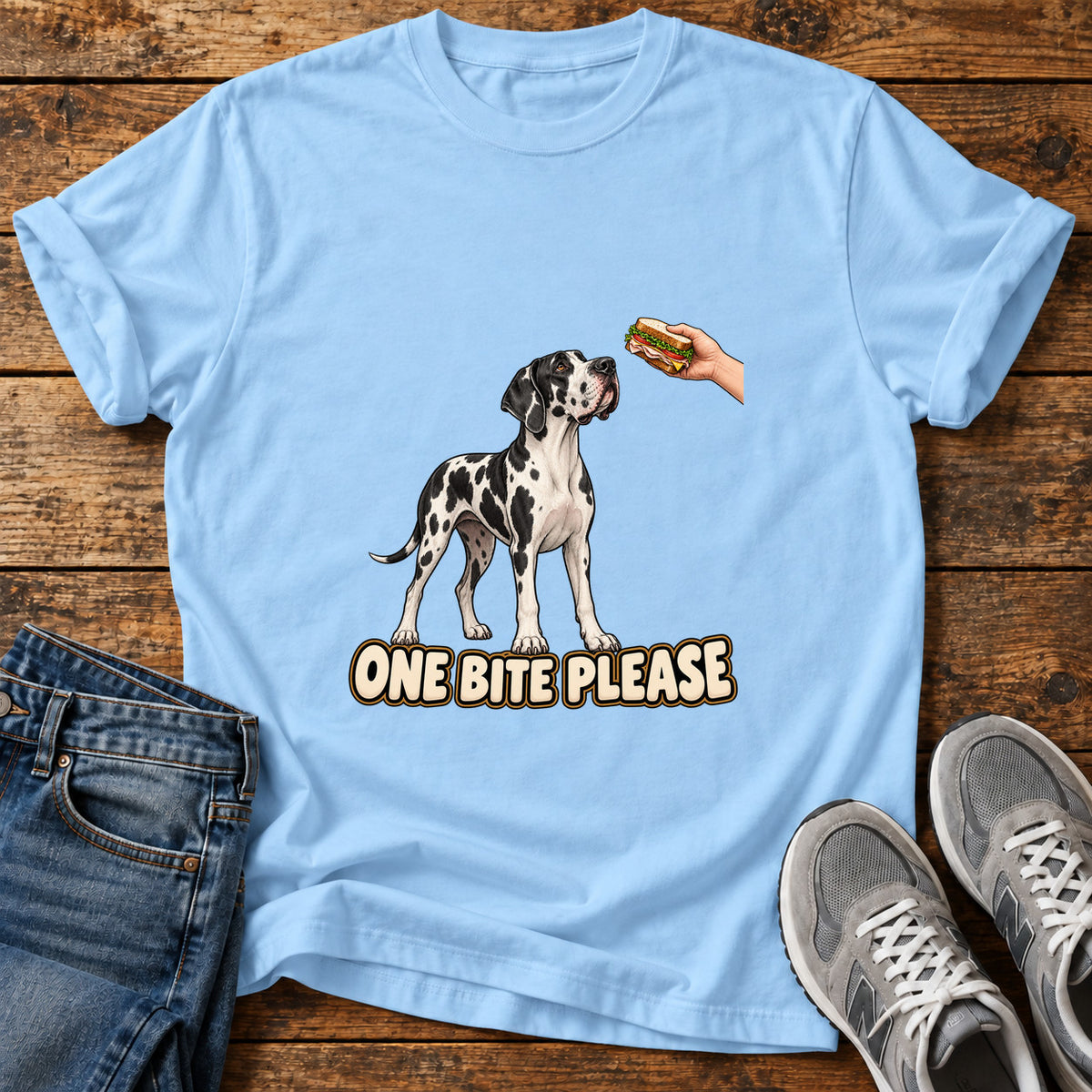 One Bite Please Great Dane graphic T-shirt in Light Blue, shown on a flat-lay shirt mockup