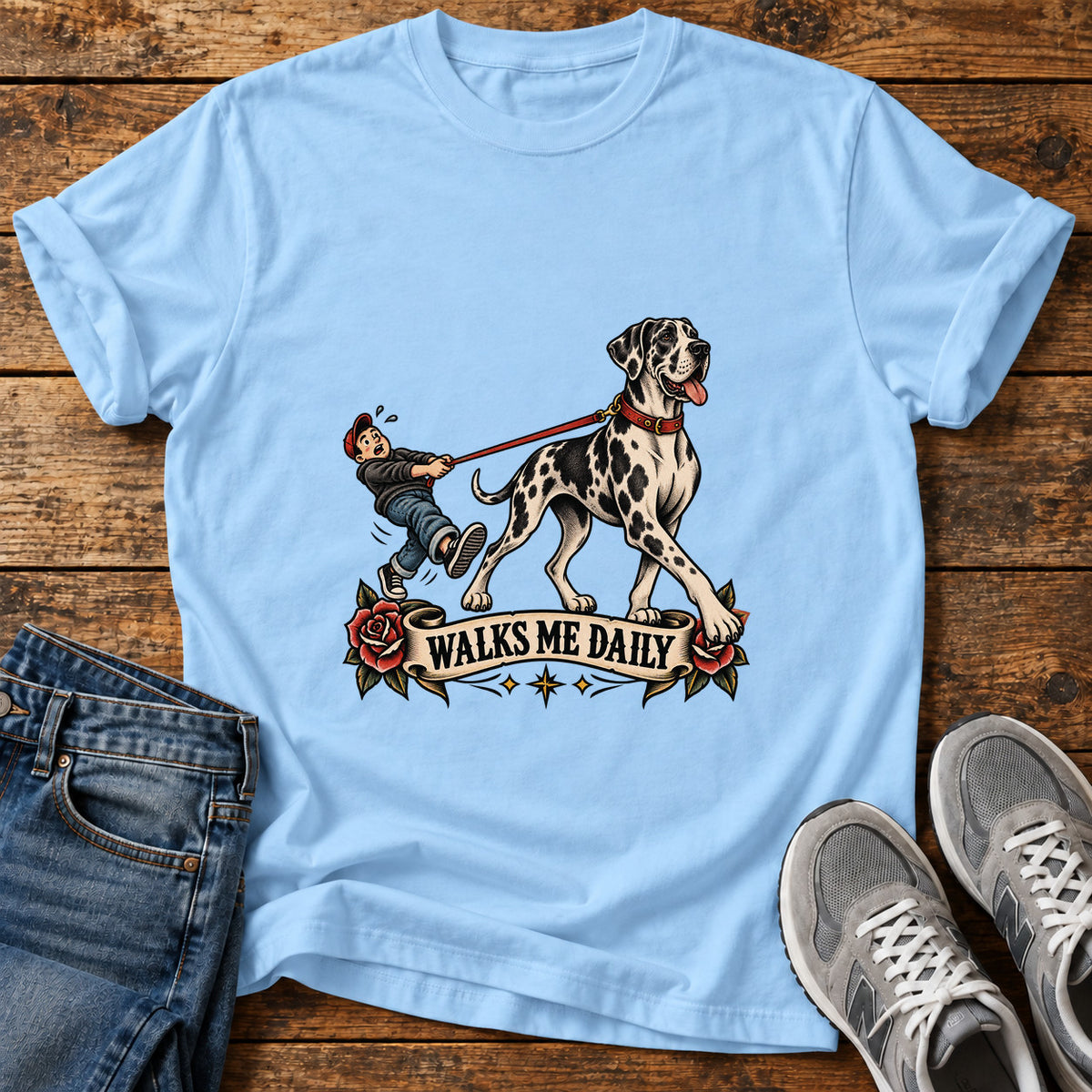 Walks Me Daily Great Dane graphic T-shirt in Light Blue, shown on a flat-lay shirt mockup