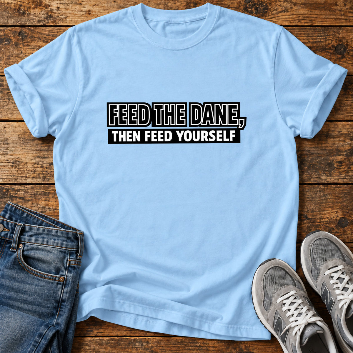 Feed The Dane Great Dane graphic T-shirt in Light Blue, shown on a flat-lay shirt mockup