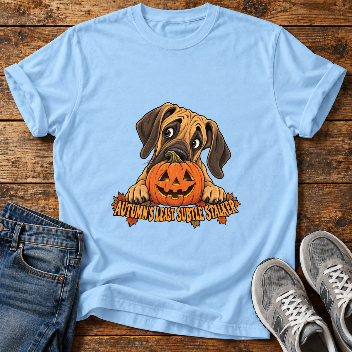 Autumn's Stalker Great Dane graphic T-shirt in Light Blue, shown on a flat-lay shirt mockup