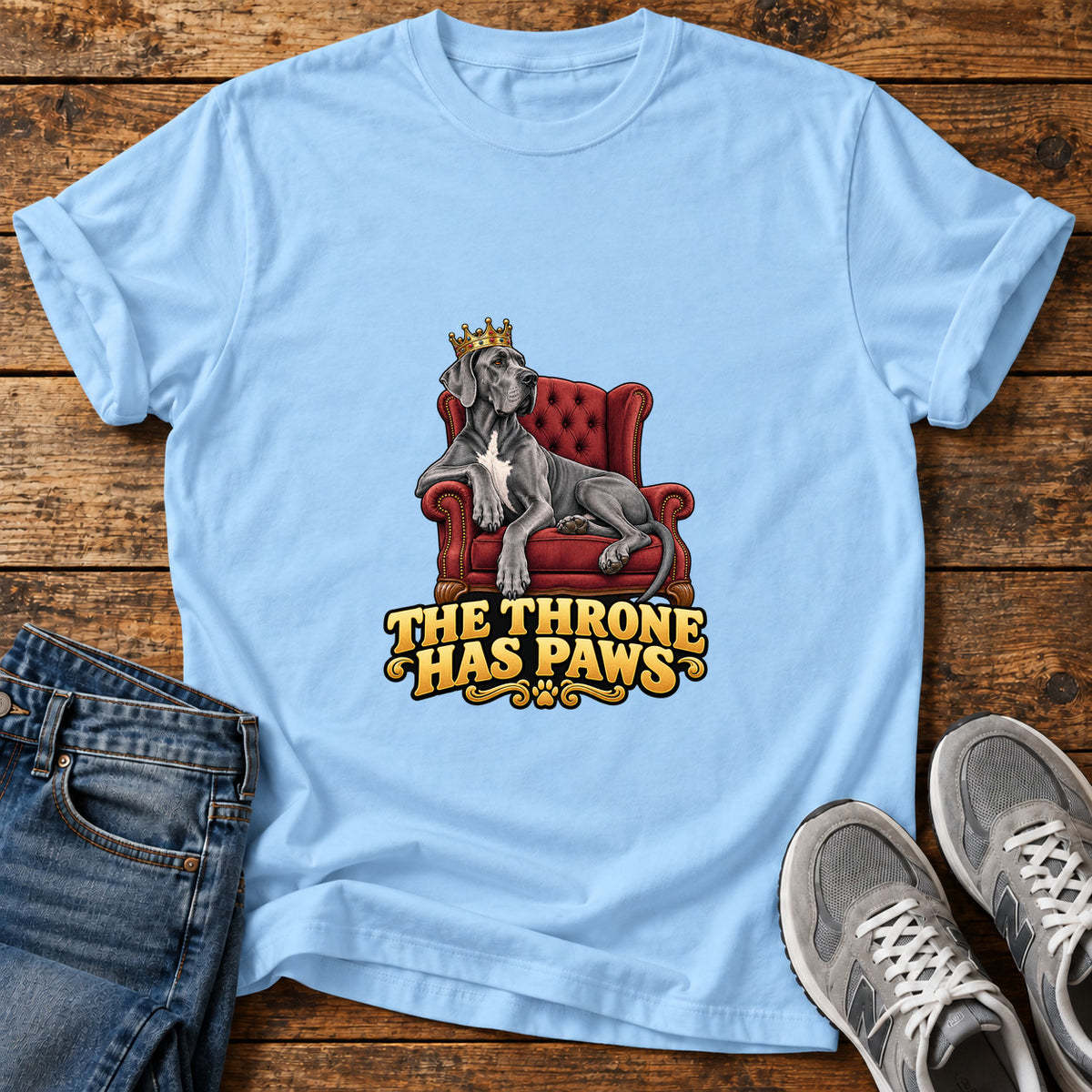 Throne Paws Majesty Great Dane graphic T-shirt in Light Blue, shown on a flat-lay shirt mockup