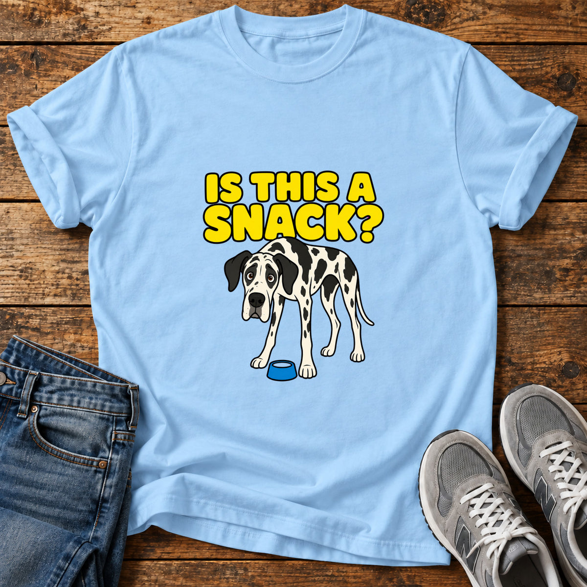 Snack Time Wonder Great Dane graphic T-shirt in Light Blue, shown on a flat-lay shirt mockup