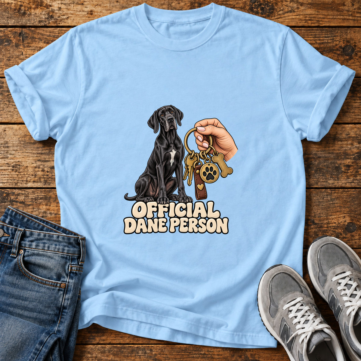 Official Dane Person Great Dane graphic T-shirt in Light Blue, shown on a flat-lay shirt mockup