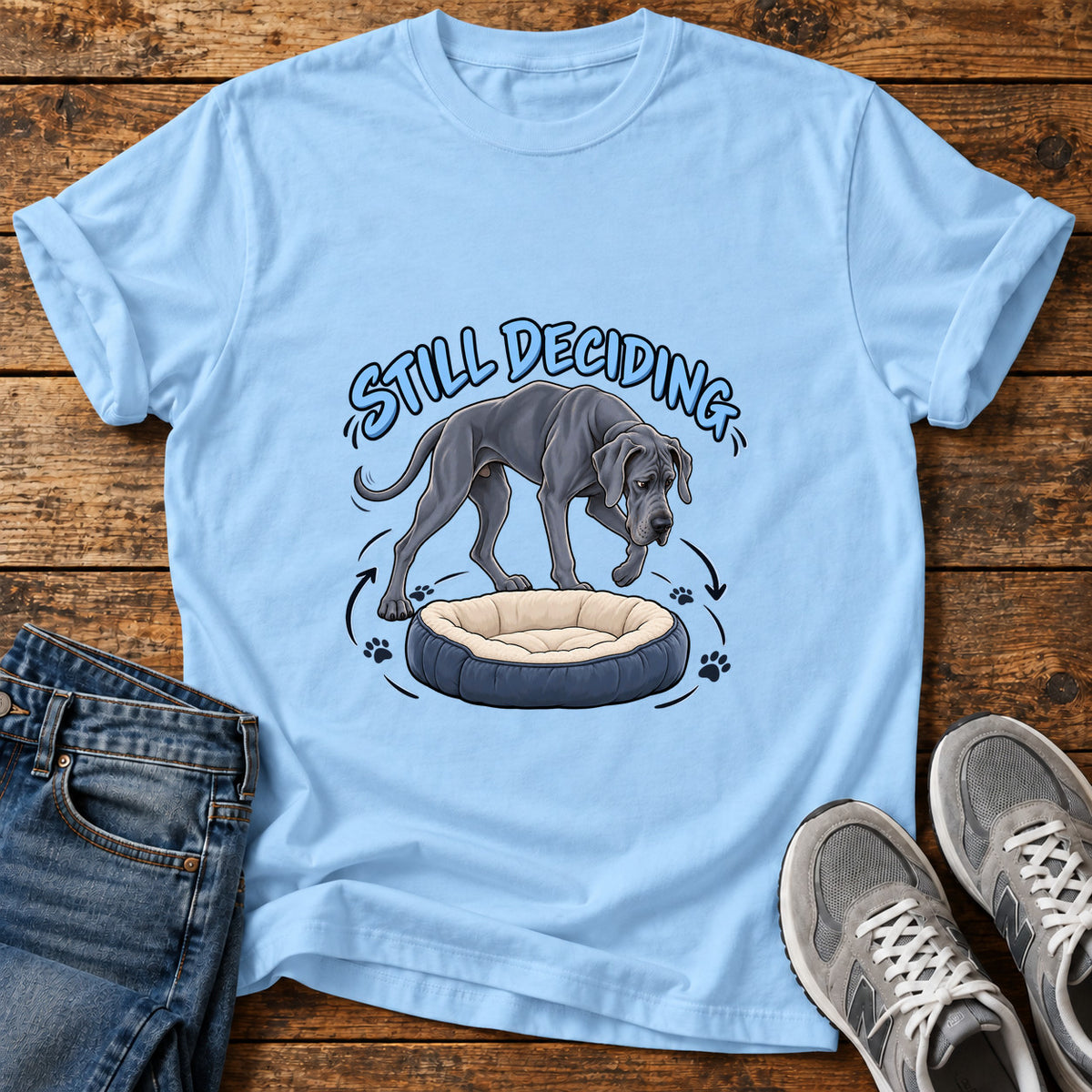 Still Deciding Great Dane graphic T-shirt in Light Blue, shown on a flat-lay shirt mockup