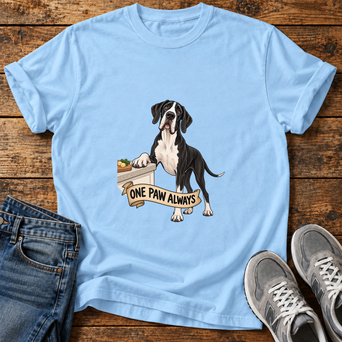 One Paw Always Great Dane graphic T-shirt in Light Blue, shown on a flat-lay shirt mockup