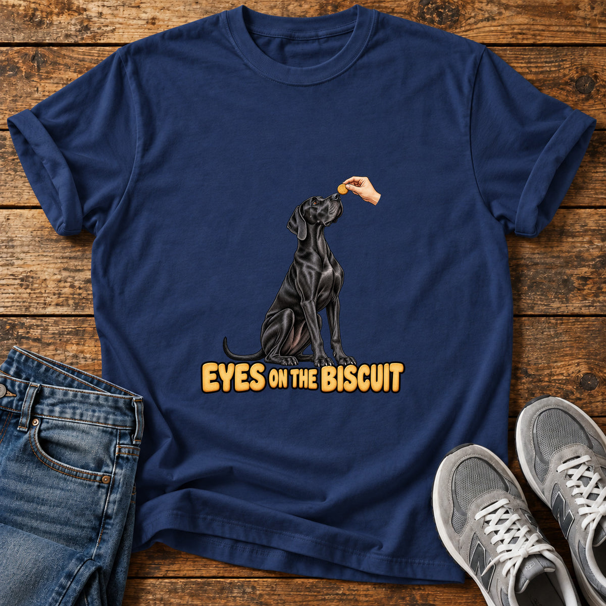 Eyes on Biscuit Great Dane graphic T-shirt in Navy, shown on a flat-lay shirt mockup