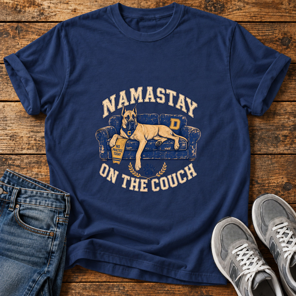 Namastay Couch Great Dane graphic T-shirt in Navy, shown on a flat-lay shirt mockup