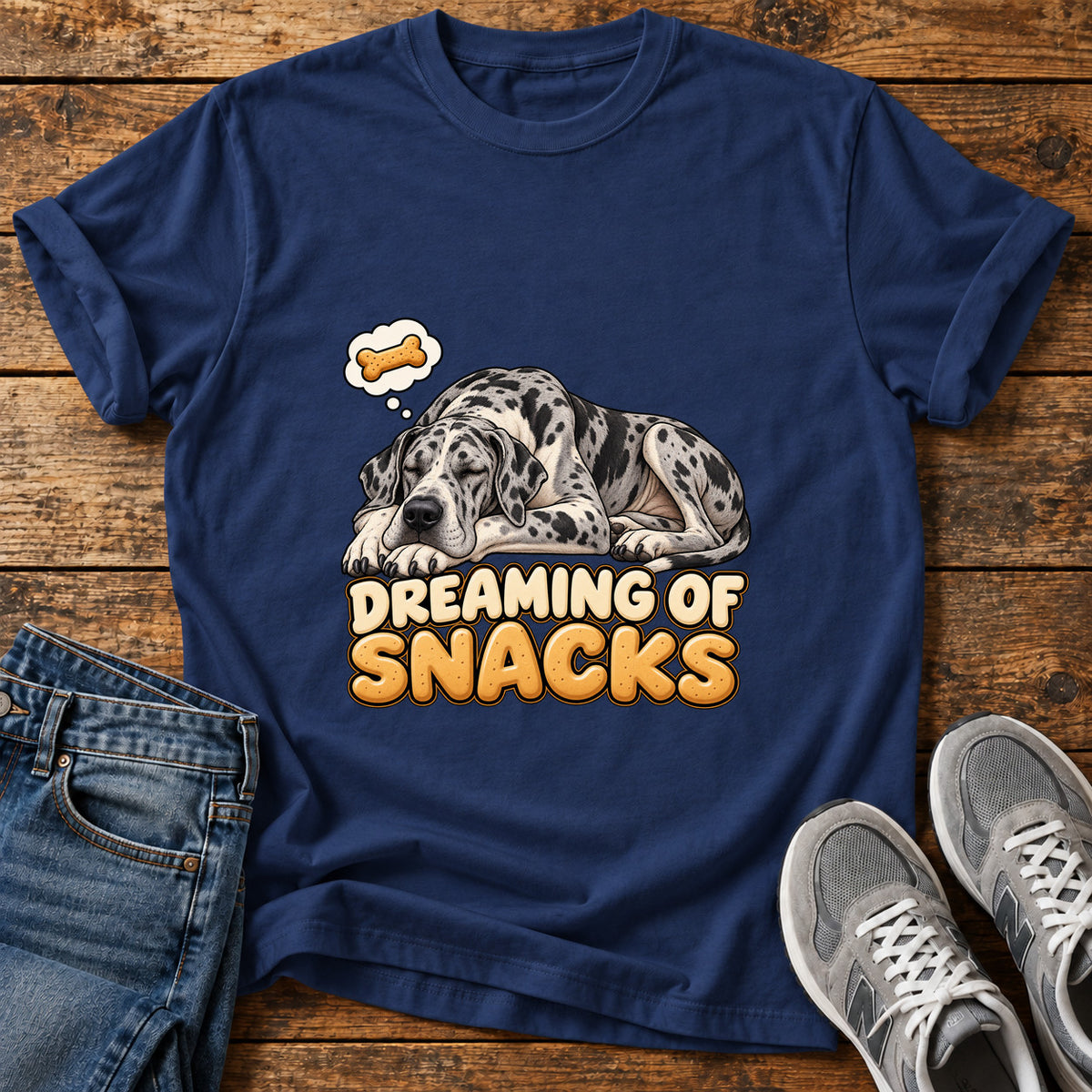 Dreaming Snacks Great Dane graphic T-shirt in Navy, shown on a flat-lay shirt mockup