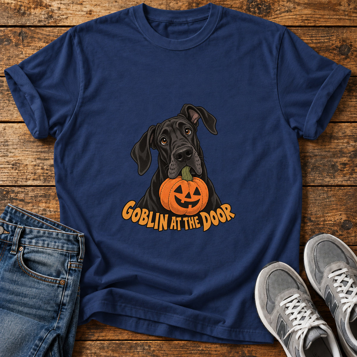 Goblin At Door Great Dane graphic T-shirt in Navy, shown on a flat-lay shirt mockup