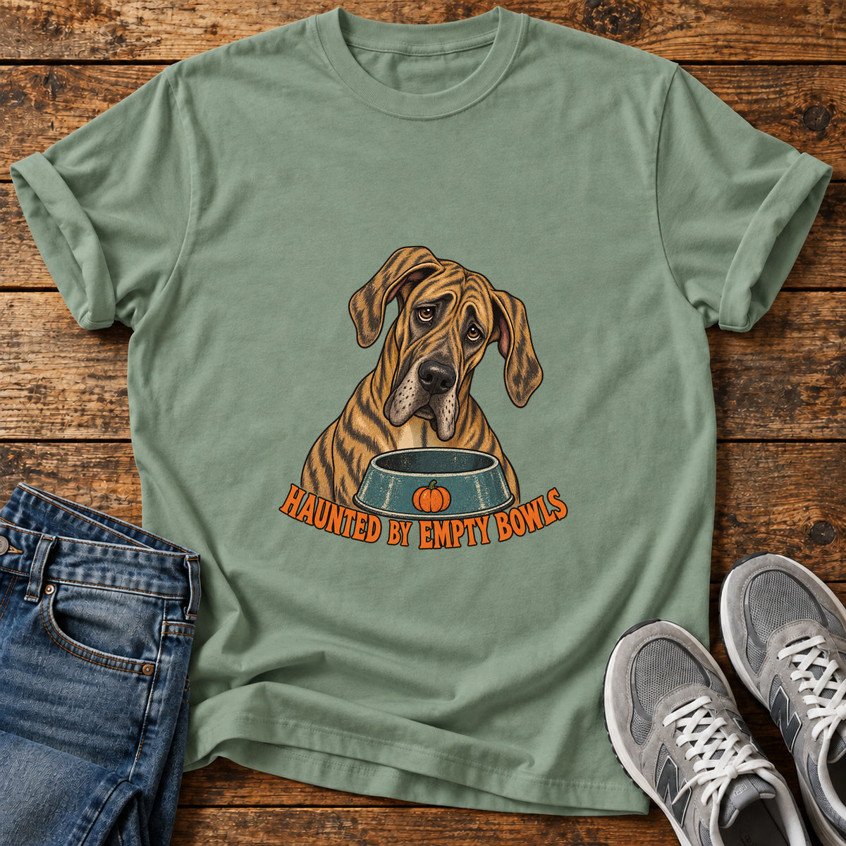 Haunted Bowls Great Dane graphic T-shirt in Sage, shown on a flat-lay shirt mockup