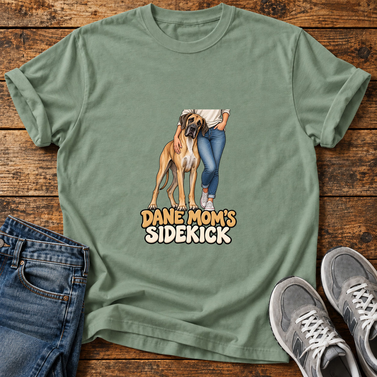 Dane Mom's Sidekick Great Dane graphic T-shirt in Sage, shown on a flat-lay shirt mockup