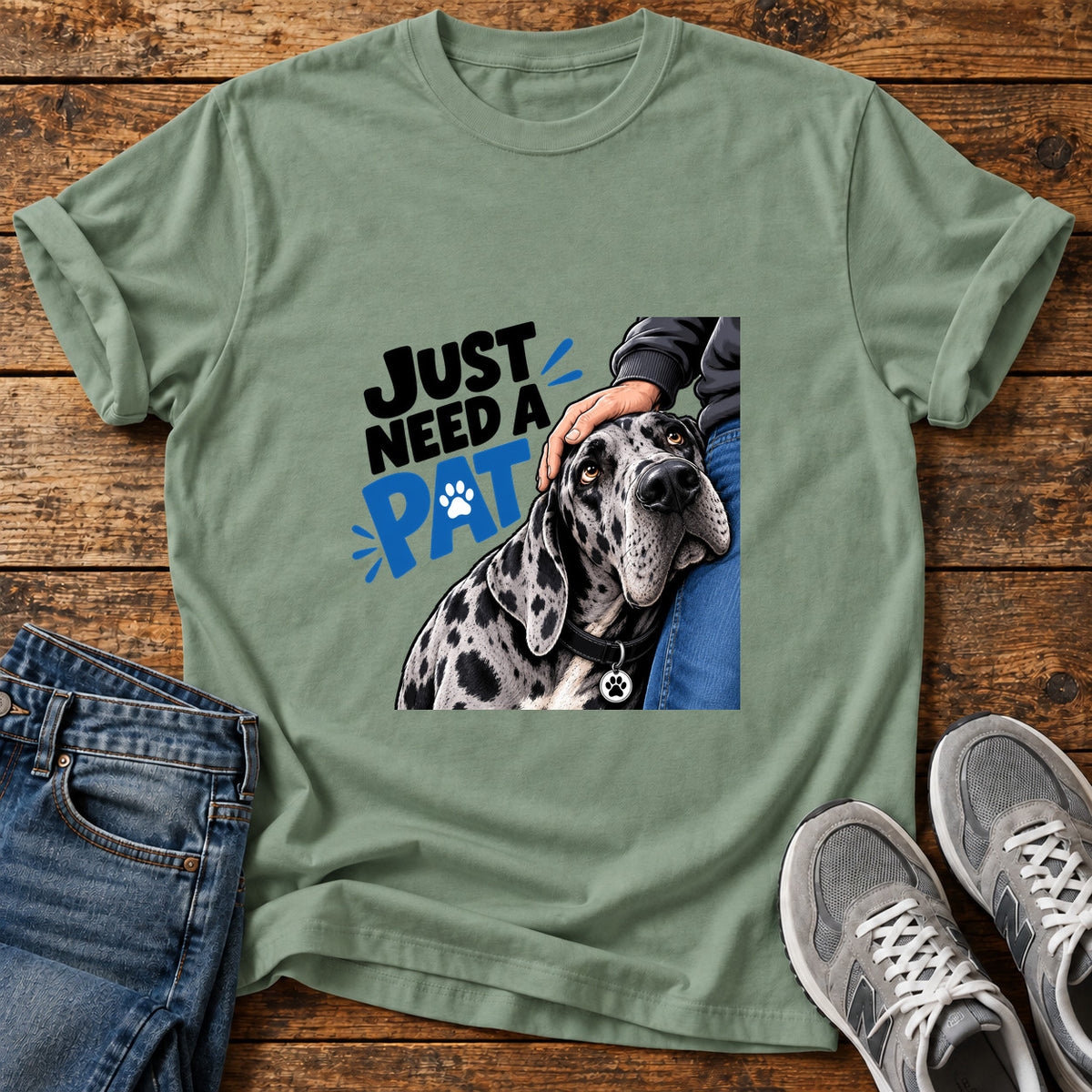 Just Need Pat Great Dane graphic T-shirt in Sage, shown on a flat-lay shirt mockup