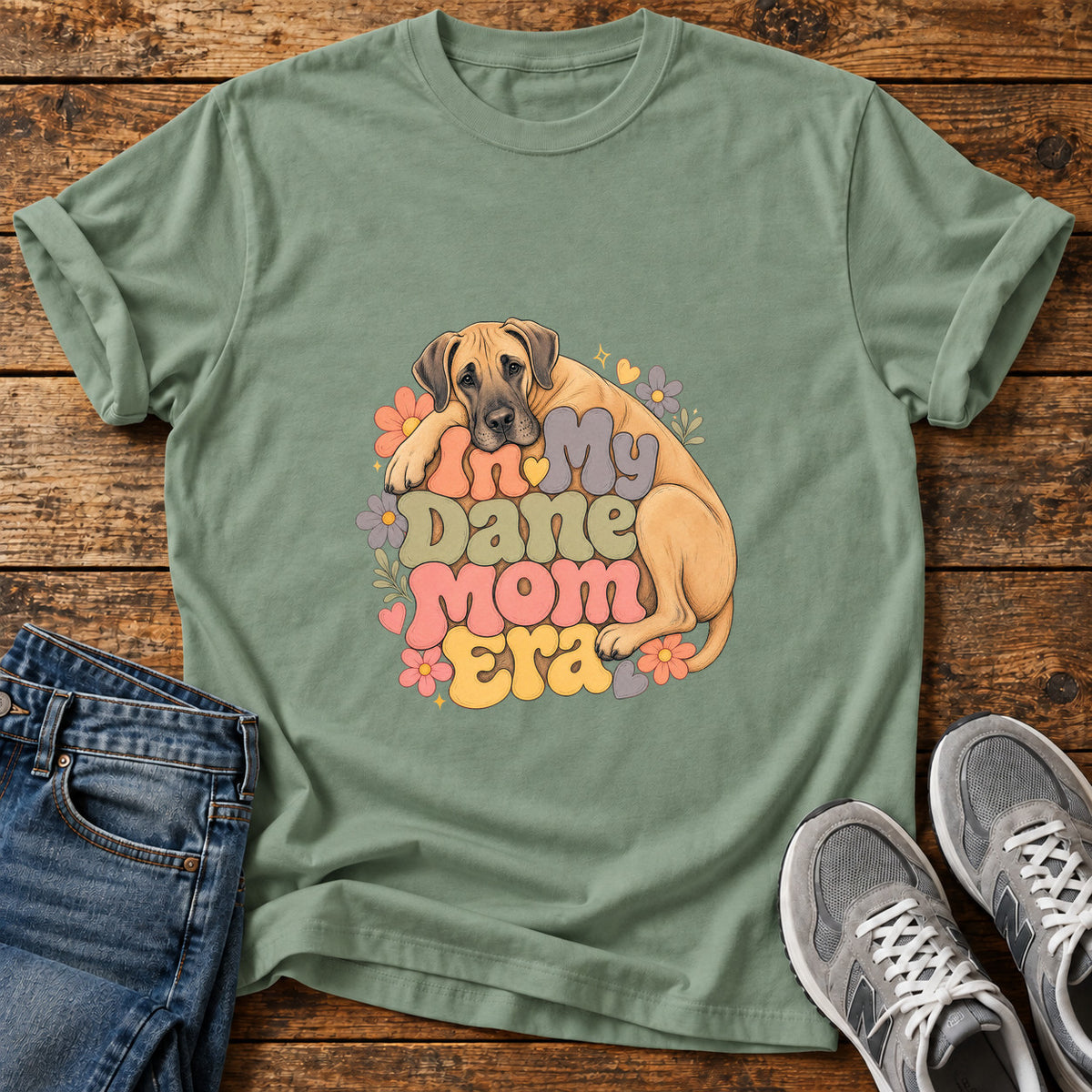Dane Mom Era Great Dane graphic T-shirt in Sage, shown on a flat-lay shirt mockup
