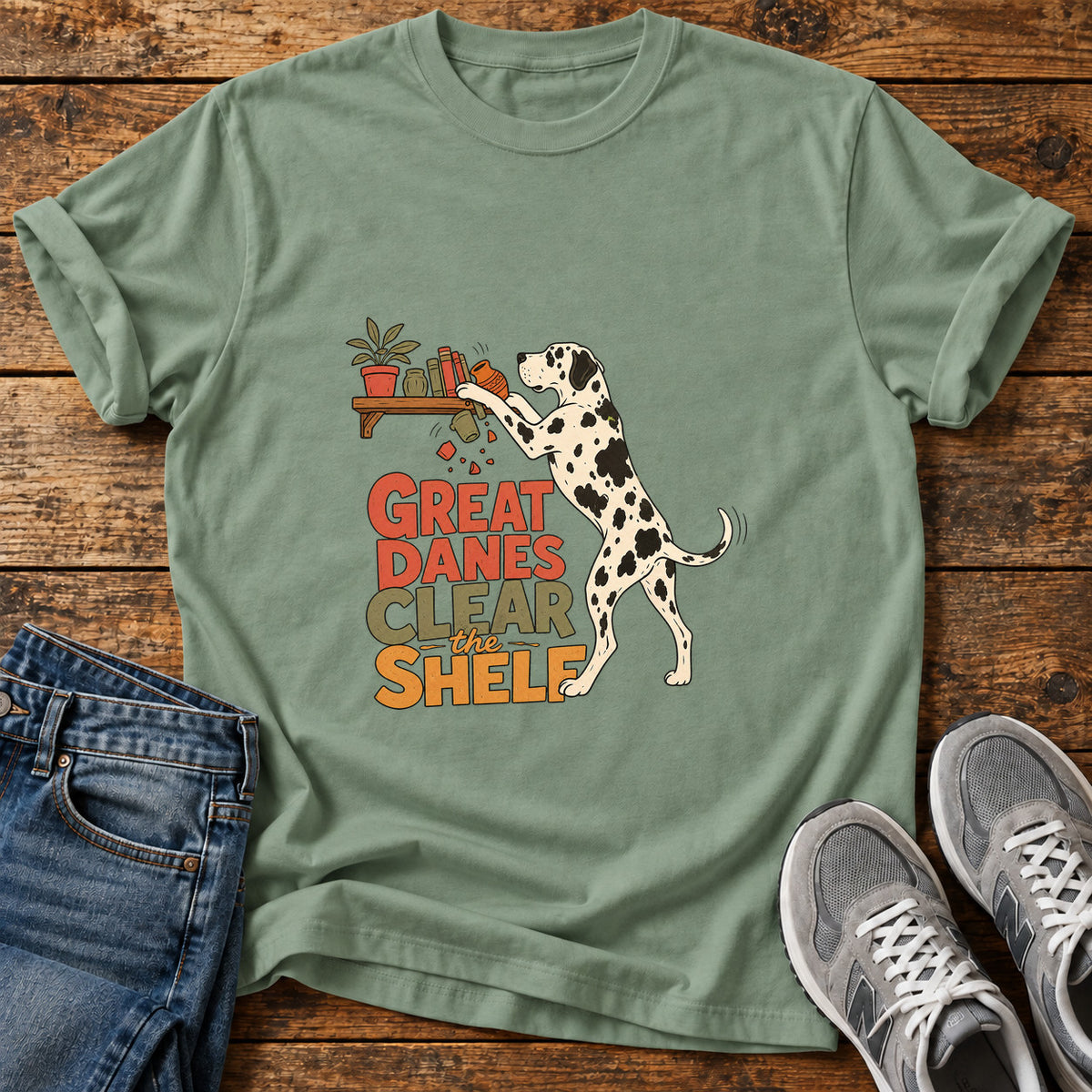 Great Danes Shelf graphic T-shirt in Sage, shown on a flat-lay shirt mockup