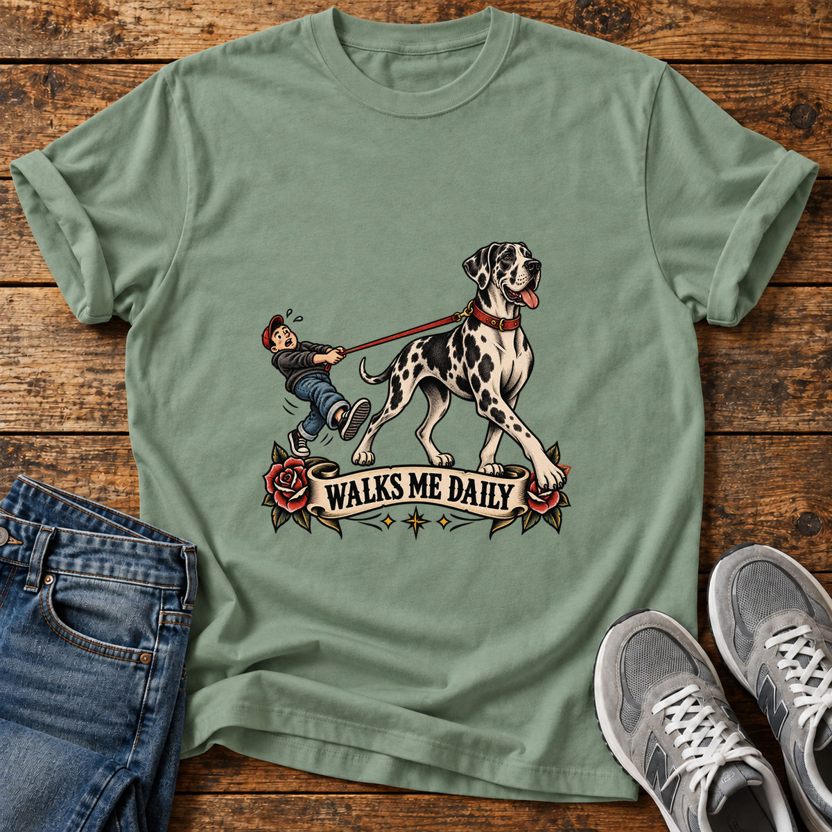 Walks Me Daily Great Dane graphic T-shirt in Sage, shown on a flat-lay shirt mockup