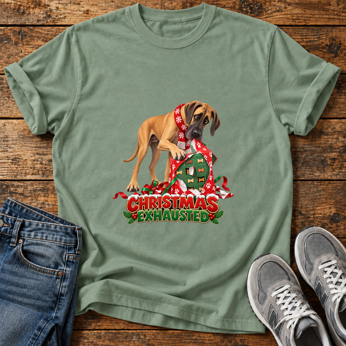 Christmas Exhausted Great Dane graphic T-shirt in Sage, shown on a flat-lay shirt mockup