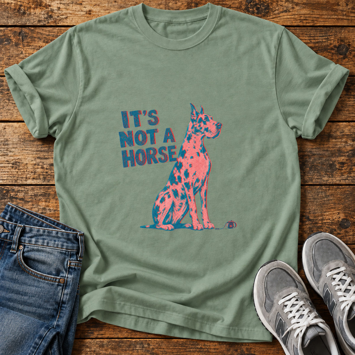It's Not A Great Dane graphic T-shirt in Sage, shown on a flat-lay shirt mockup