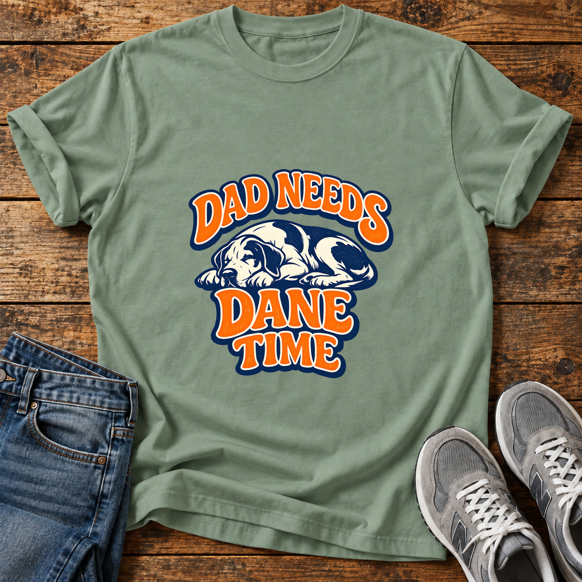 Dad Needs Dane Great Dane graphic T-shirt in Sage, shown on a flat-lay shirt mockup