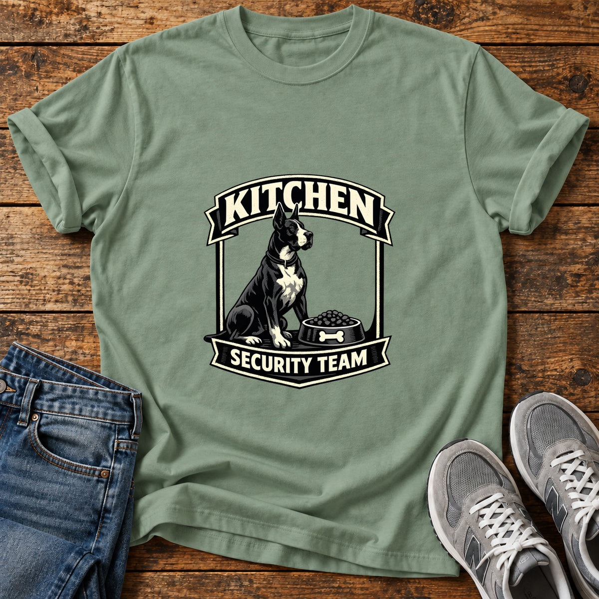 Kitchen Security Great Dane graphic T-shirt in Sage, shown on a flat-lay shirt mockup
