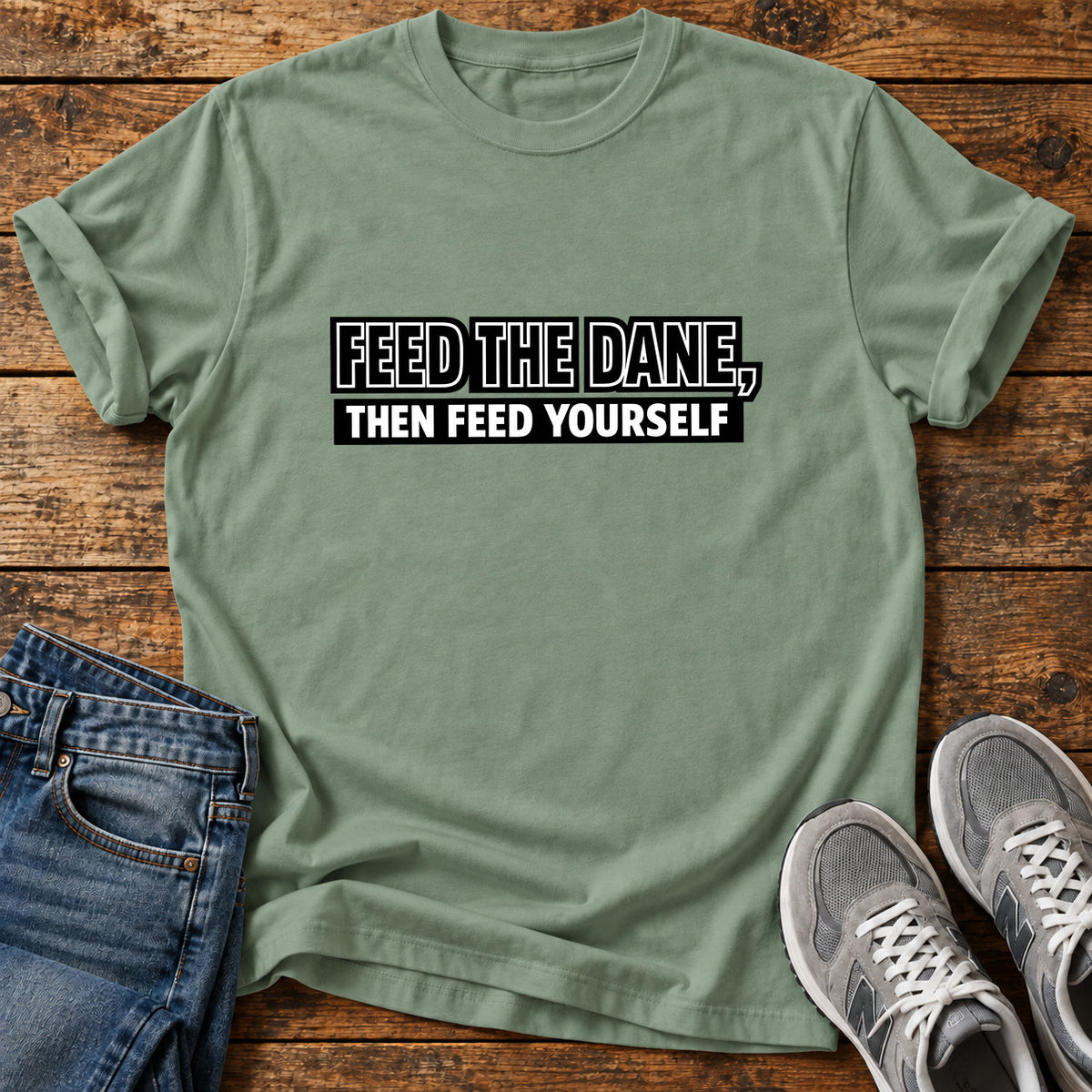 Feed The Dane Great Dane graphic T-shirt in Sage, shown on a flat-lay shirt mockup