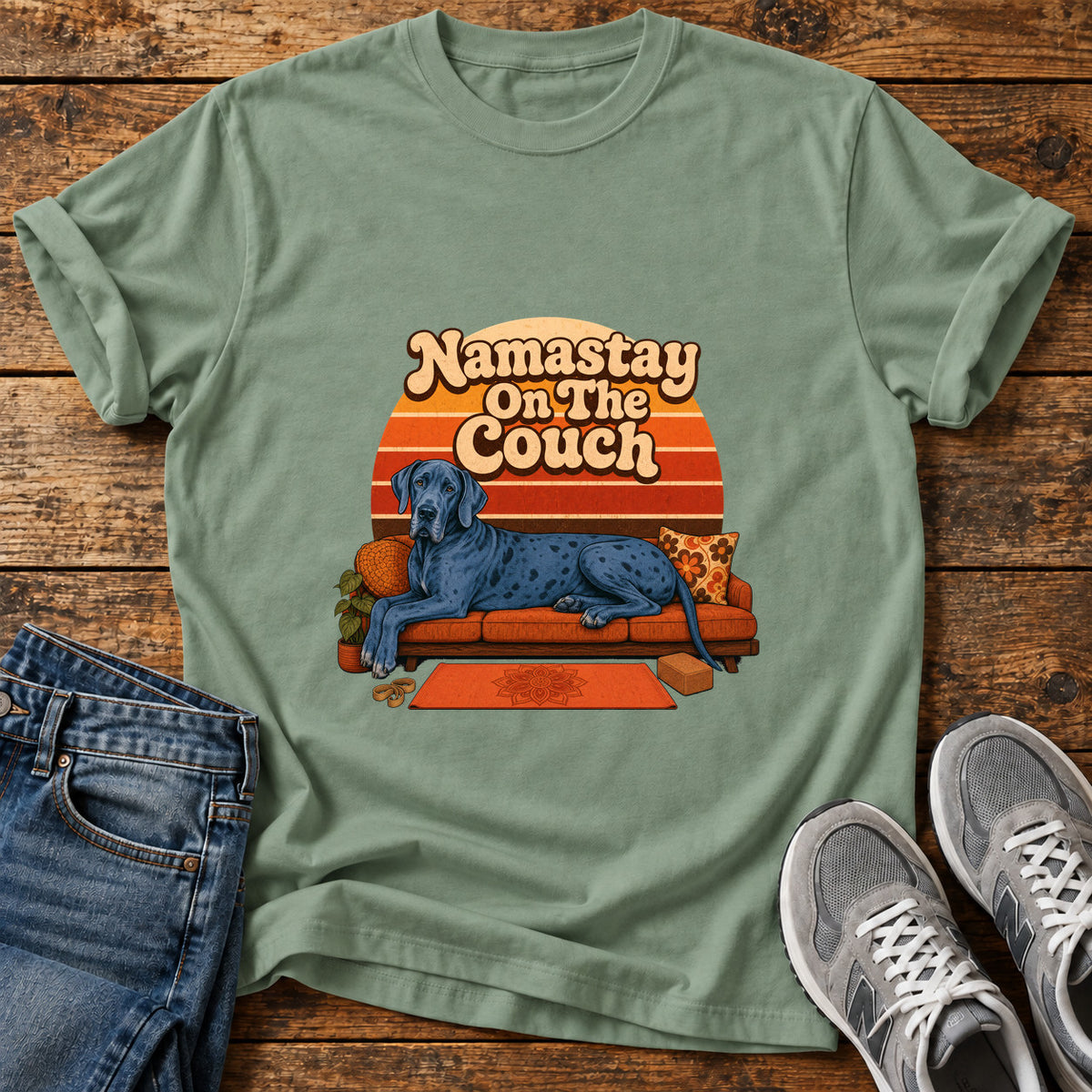 Namastay Couch Pooch Great Dane graphic T-shirt in Sage, shown on a flat-lay shirt mockup