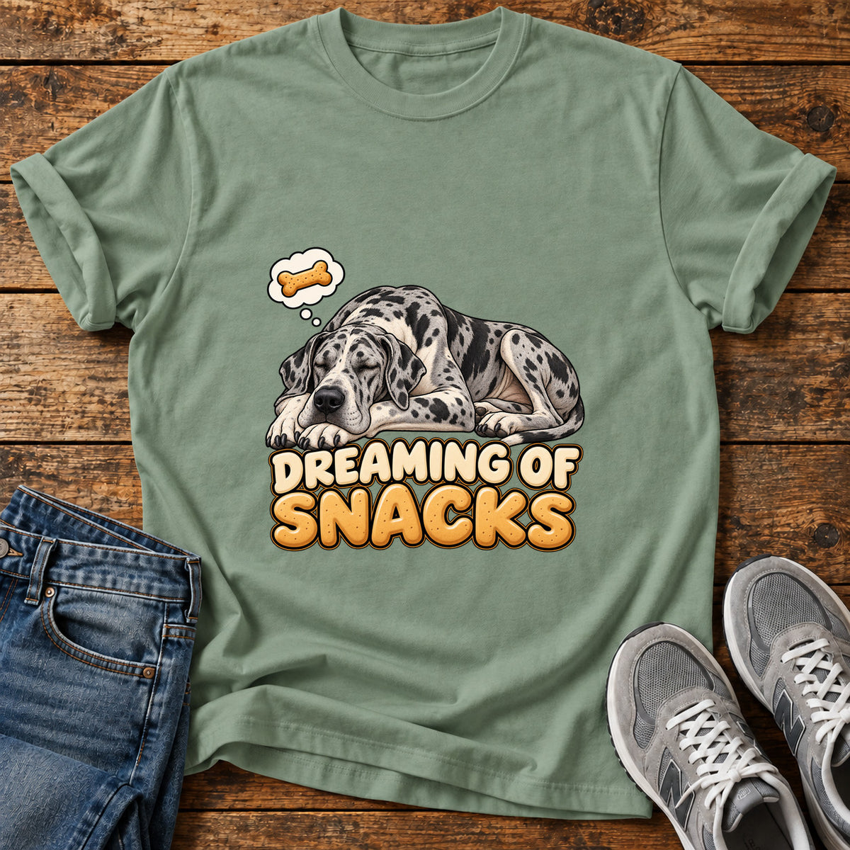 Dreaming Snacks Great Dane graphic T-shirt in Sage, shown on a flat-lay shirt mockup