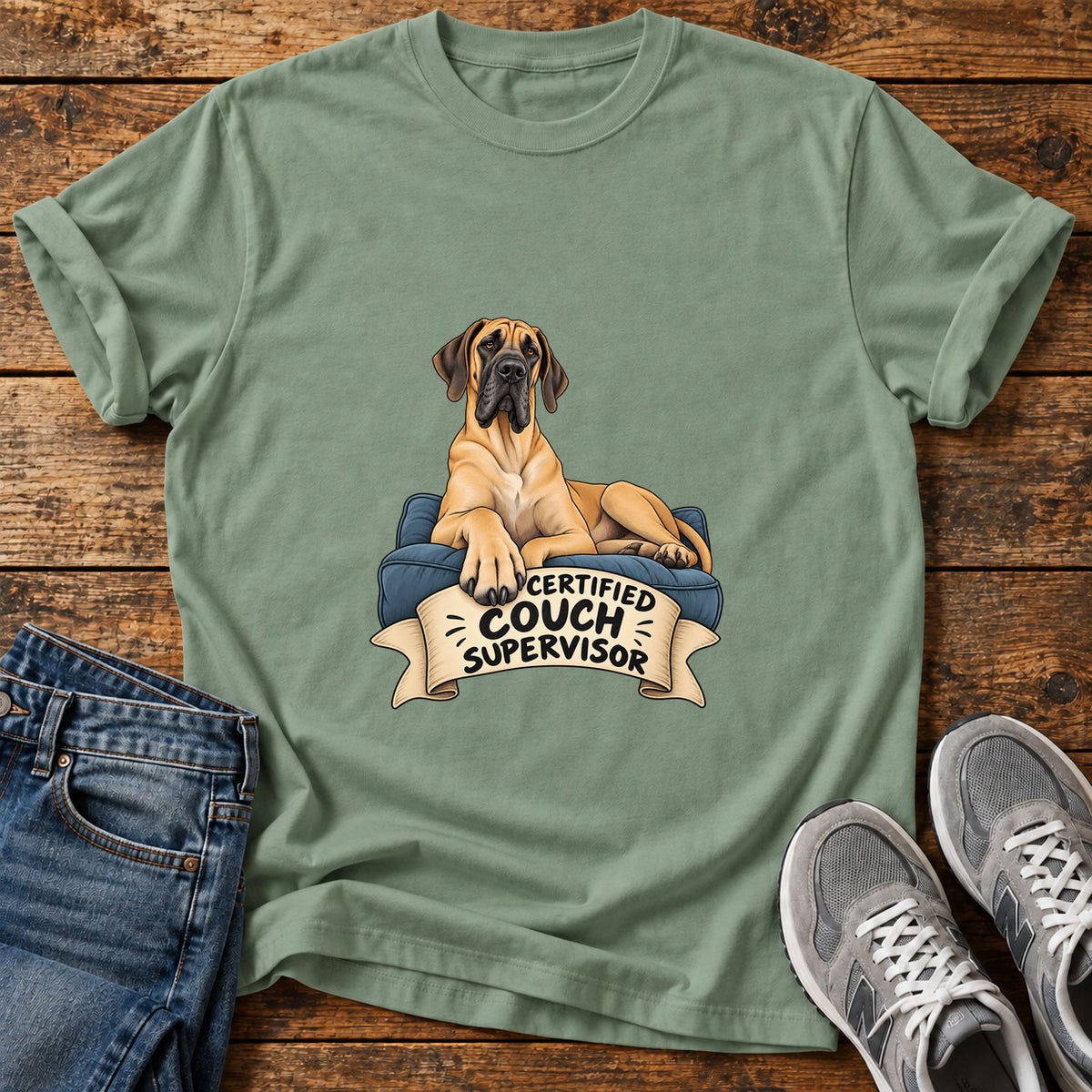 Certified Couch Supervisor Great Dane graphic T-shirt in Sage, shown on a flat-lay shirt mockup