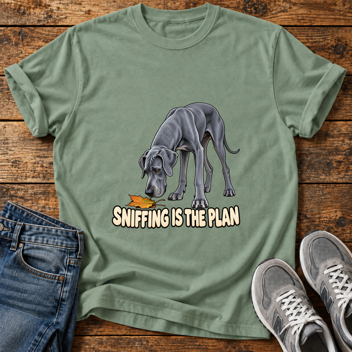 Sniffing Plan Great Dane graphic T-shirt in Sage, shown on a flat-lay shirt mockup