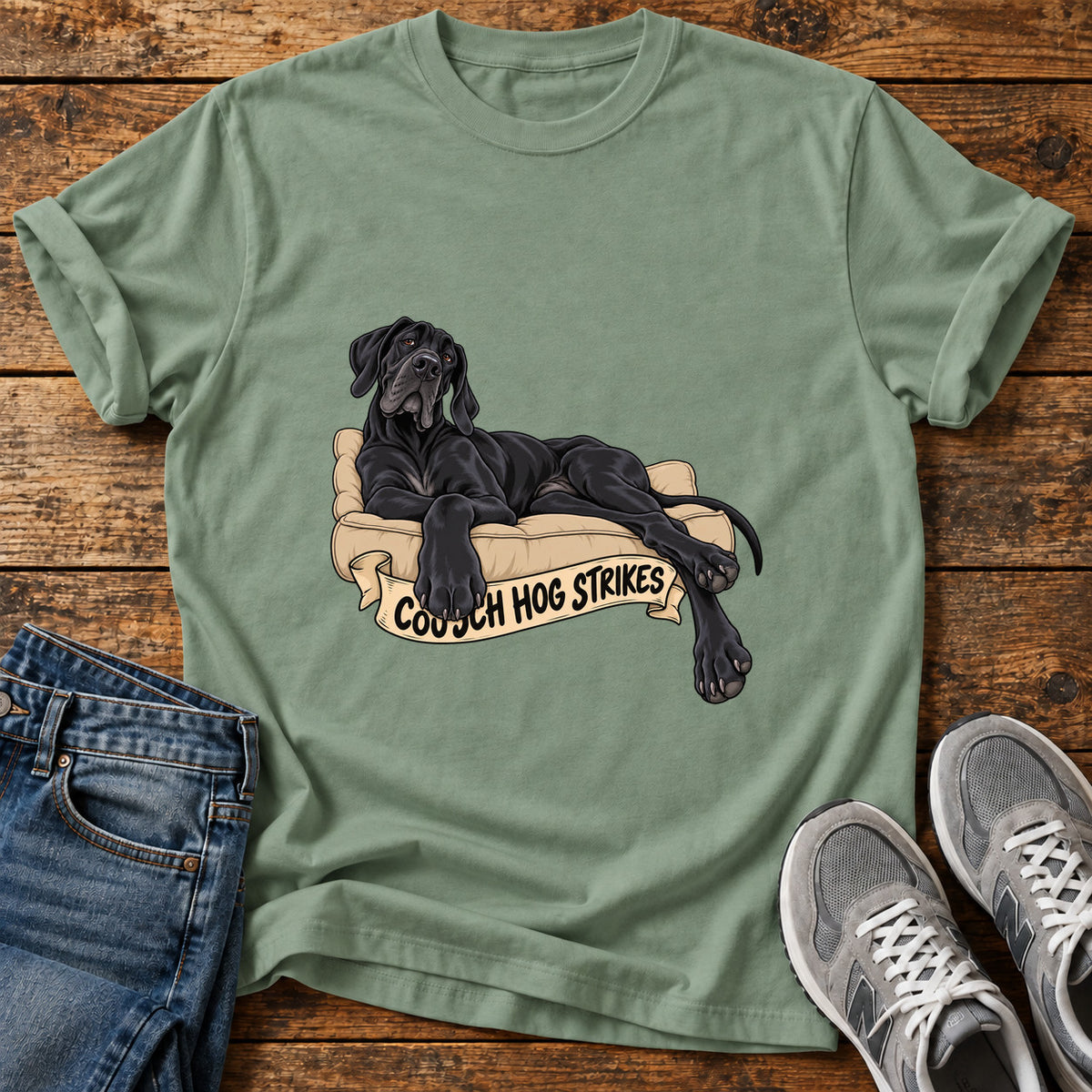 Couch Hog Strikes Great Dane graphic T-shirt in Sage, shown on a flat-lay shirt mockup