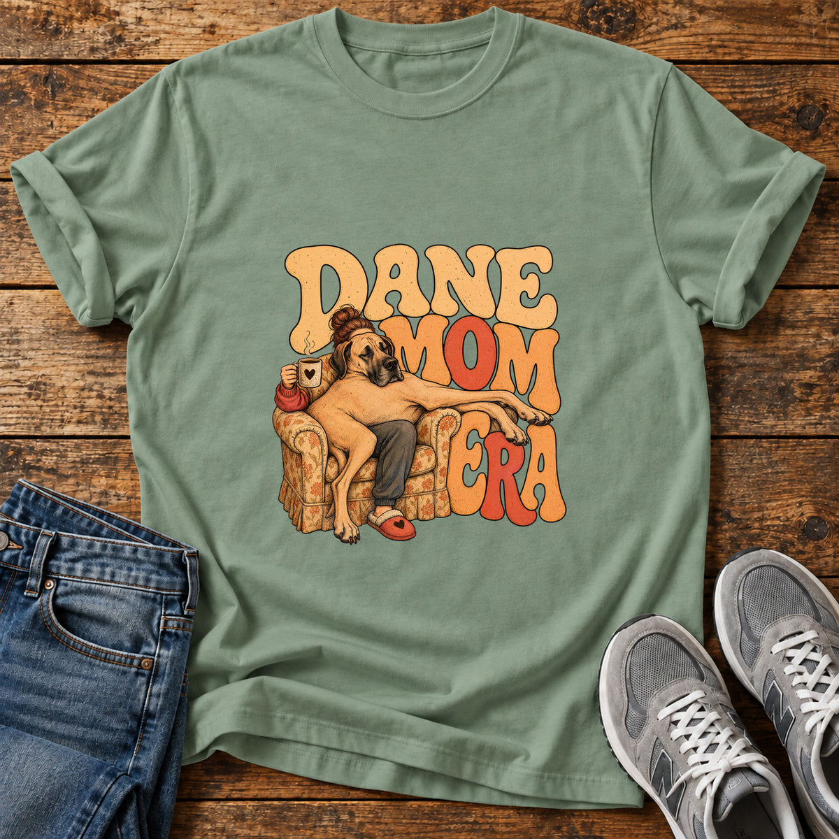 Dane Mom Era Great Dane graphic T-shirt in Sage, shown on a flat-lay shirt mockup