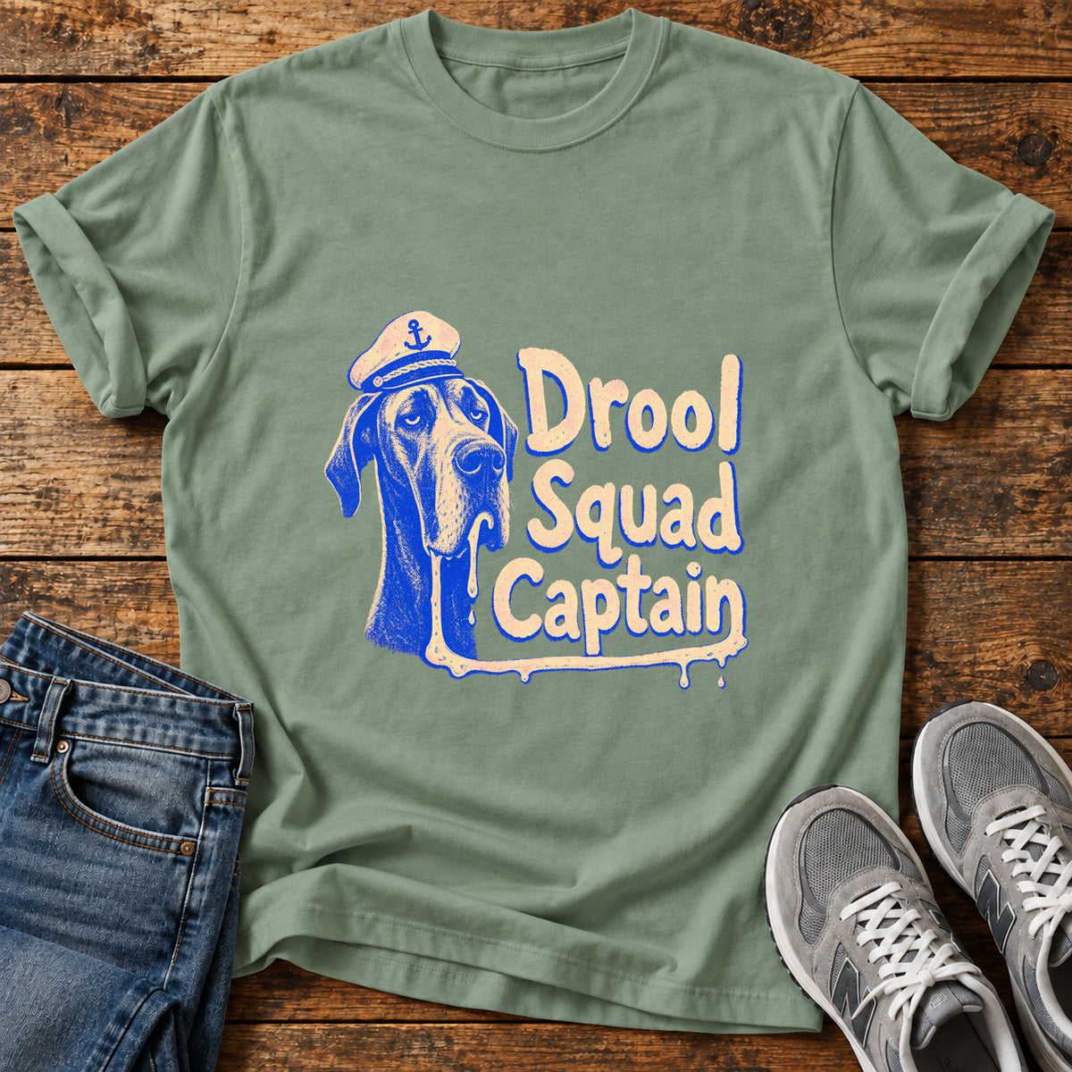 Drool Squad Captain Great Dane graphic T-shirt in Sage, shown on a flat-lay shirt mockup
