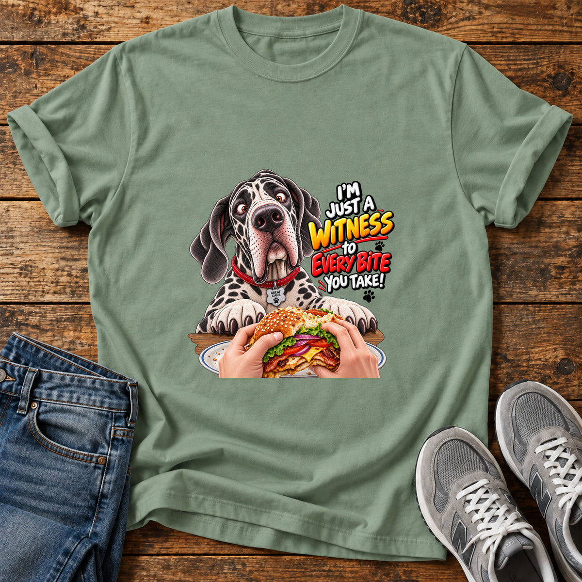 Witness Every Bite Great Dane graphic T-shirt in Sage, shown on a flat-lay shirt mockup