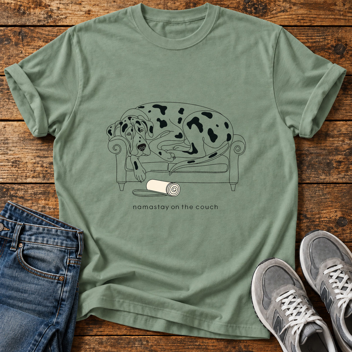 Namastay Couch Great Dane graphic T-shirt in Sage, shown on a flat-lay shirt mockup