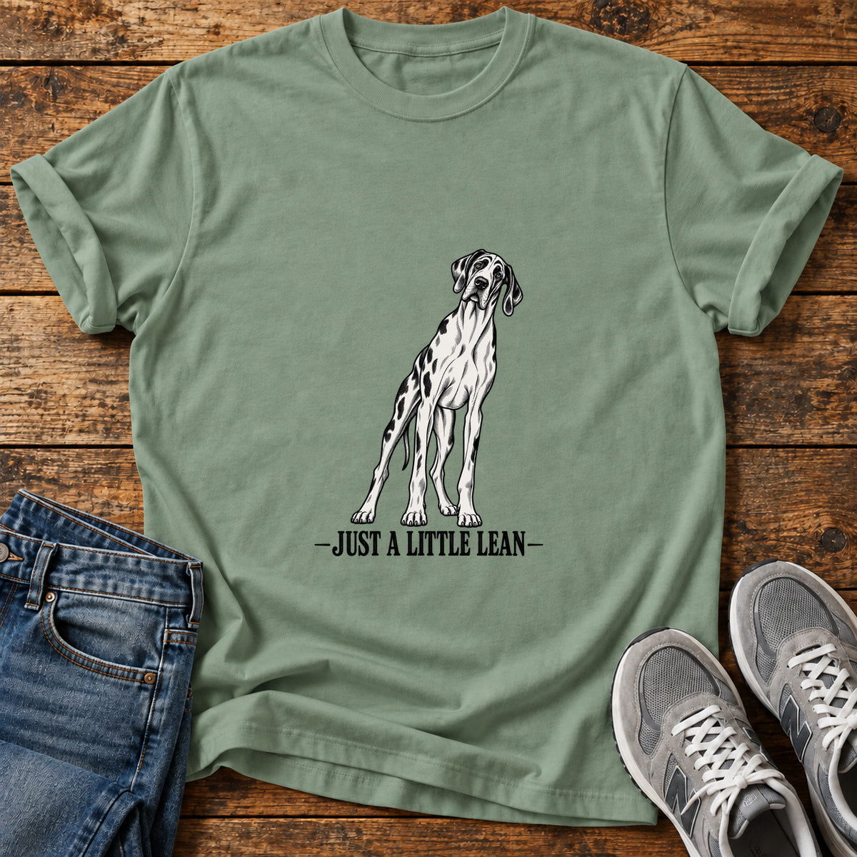 Just A Lean Great Dane graphic T-shirt in Sage, shown on a flat-lay shirt mockup