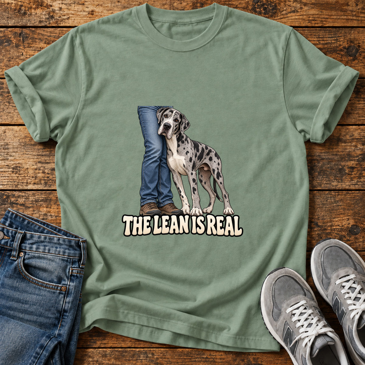 The Lean Great Dane graphic T-shirt in Sage, shown on a flat-lay shirt mockup