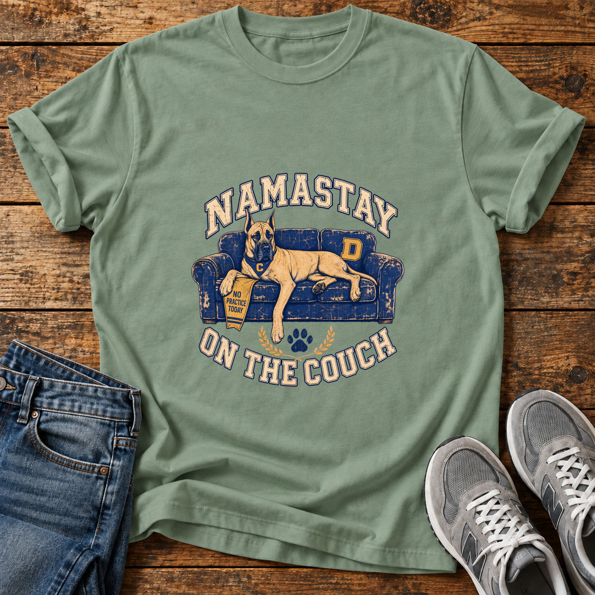 Namastay Couch Great Dane graphic T-shirt in Sage, shown on a flat-lay shirt mockup