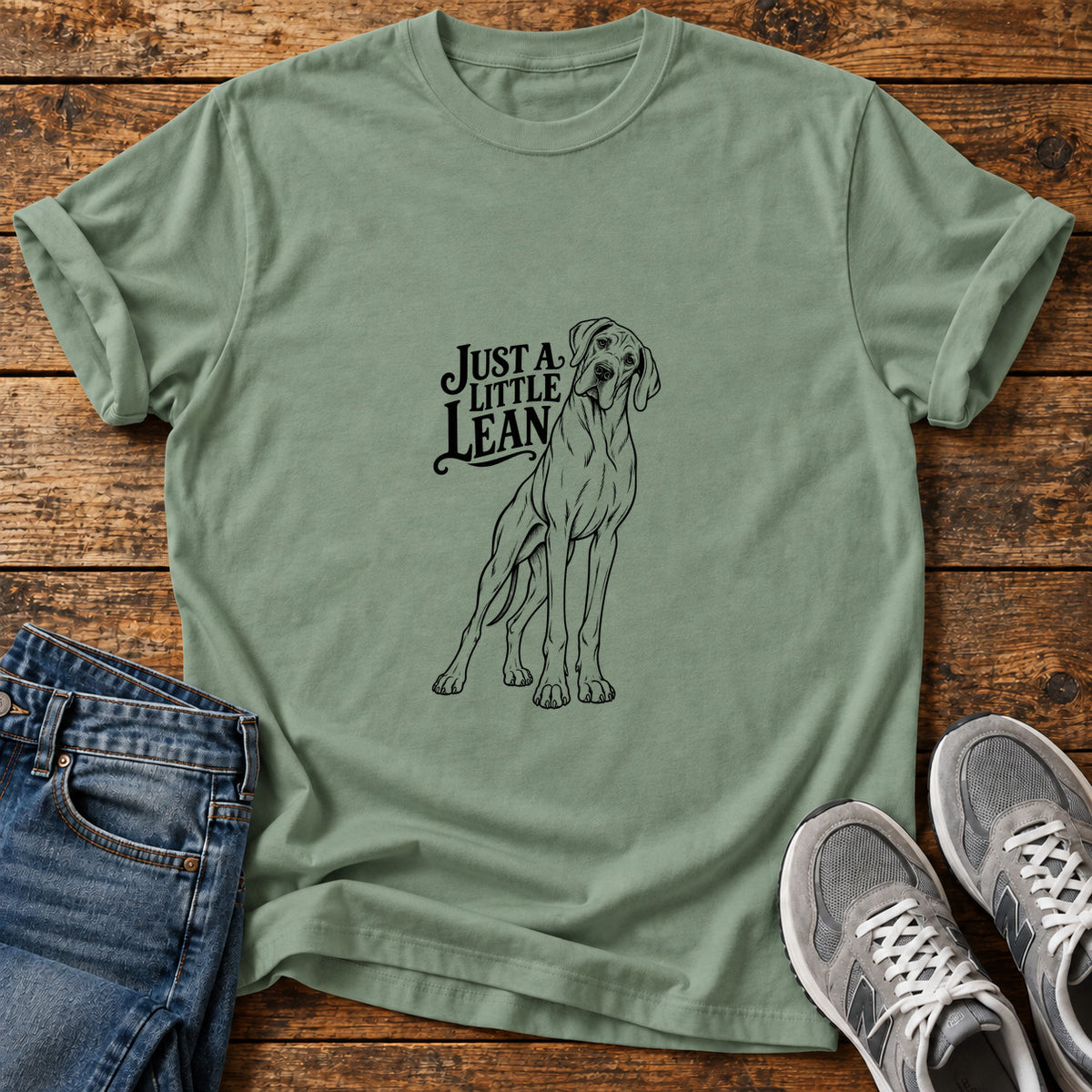 Just A Lean Great Dane graphic T-shirt in Sage, shown on a flat-lay shirt mockup