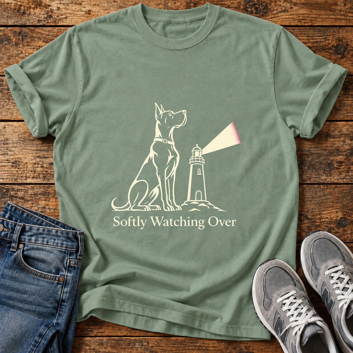 Softly Watching Over Great Dane graphic T-shirt in Sage, shown on a flat-lay shirt mockup
