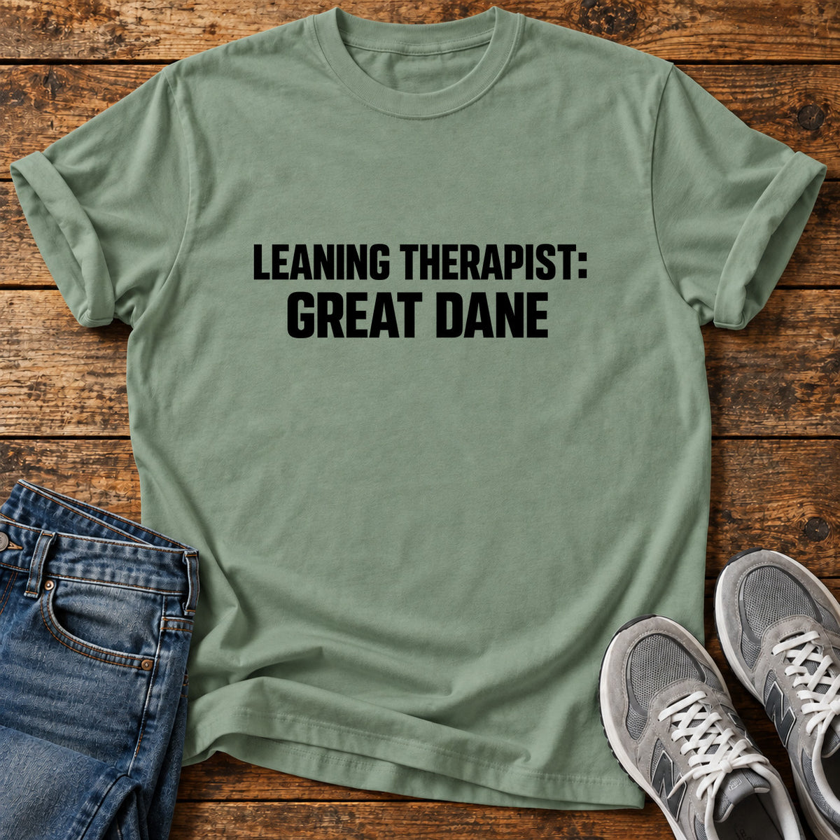 Leaning Therapist Great Dane graphic T-shirt in Sage, shown on a flat-lay shirt mockup
