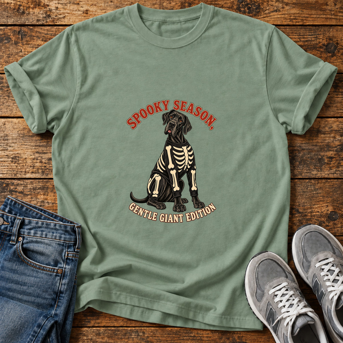Spooky Gentle Giant Great Dane graphic T-shirt in Sage, shown on a flat-lay shirt mockup