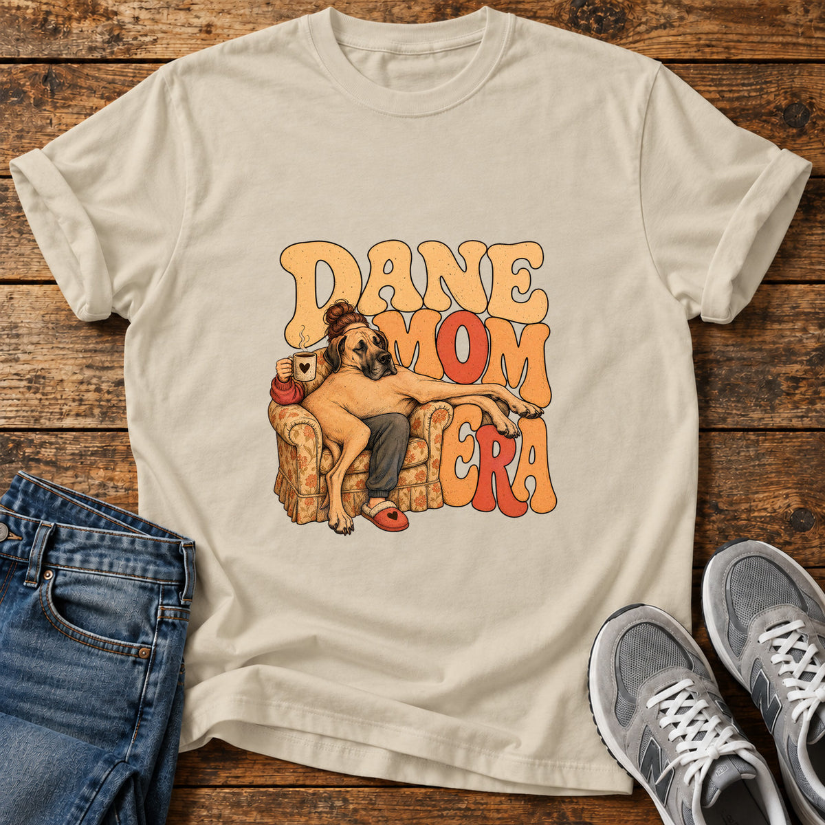 Dane Mom Era Great Dane graphic T-shirt in Sand, shown on a flat-lay shirt mockup