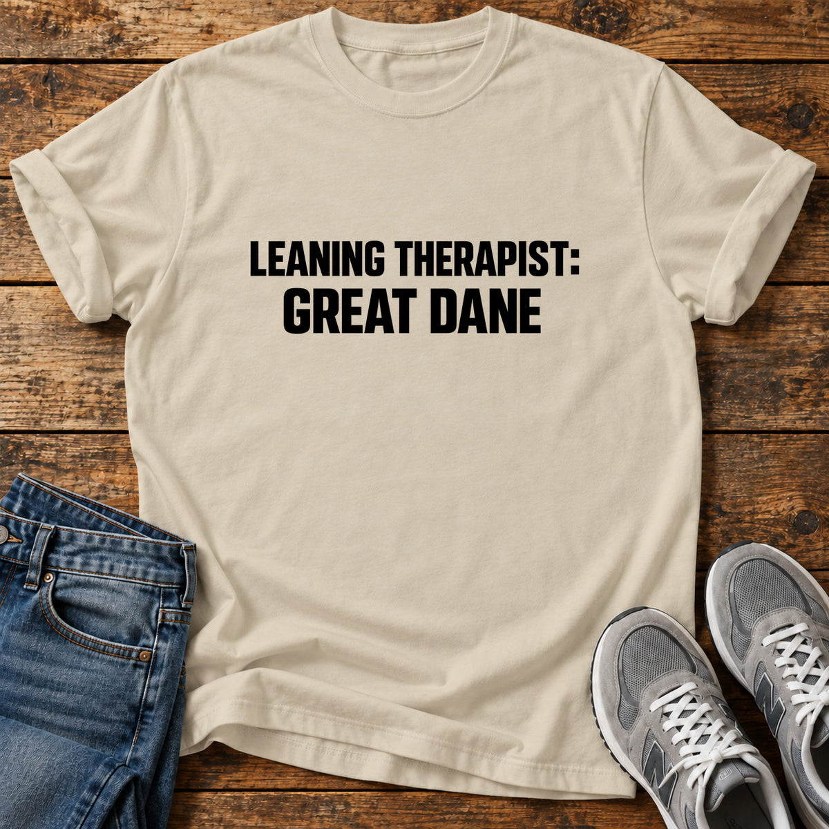 Leaning Therapist Great Dane graphic T-shirt in Sand, shown on a flat-lay shirt mockup