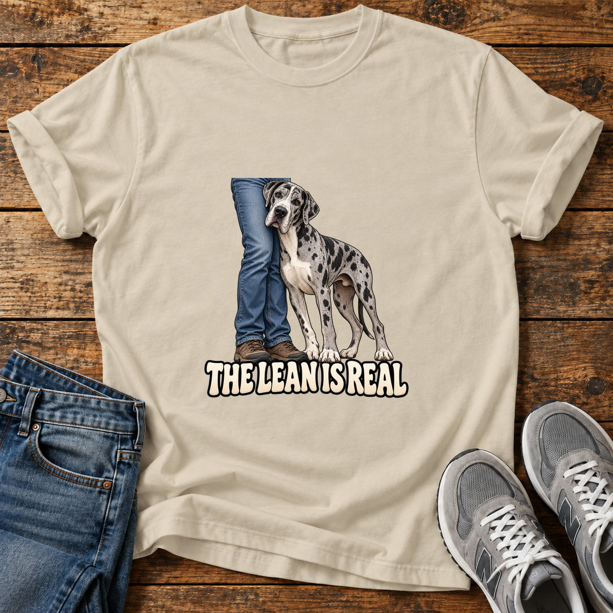 The Lean Great Dane graphic T-shirt in Sand, shown on a flat-lay shirt mockup
