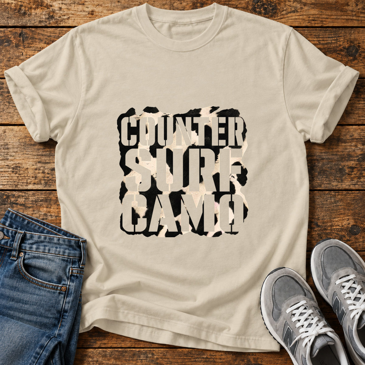 Counter Surf Camo Great Dane graphic T-shirt in Sand, shown on a flat-lay shirt mockup
