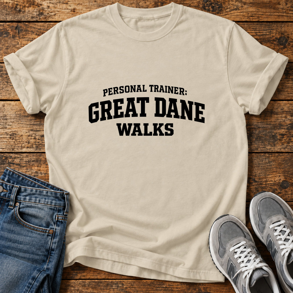 Great Dane Trainer graphic T-shirt in Sand, shown on a flat-lay shirt mockup