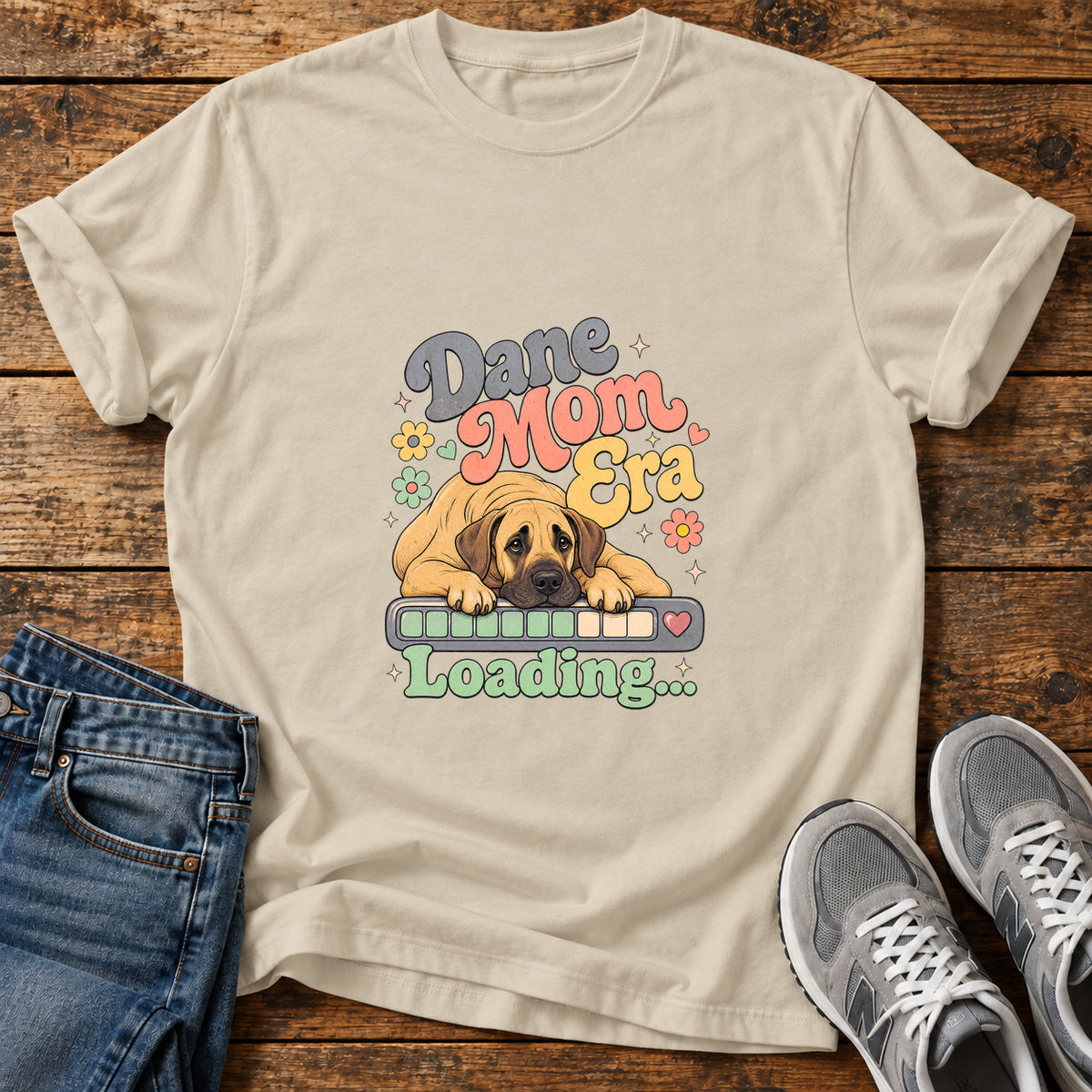 Dane Mom Loading Great Dane graphic T-shirt in Sand, shown on a flat-lay shirt mockup