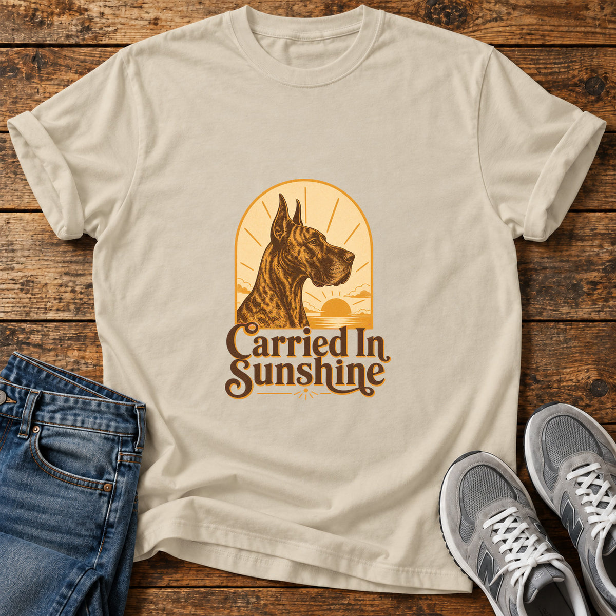 Carried In Sunshine Great Dane graphic T-shirt in Sand, shown on a flat-lay shirt mockup