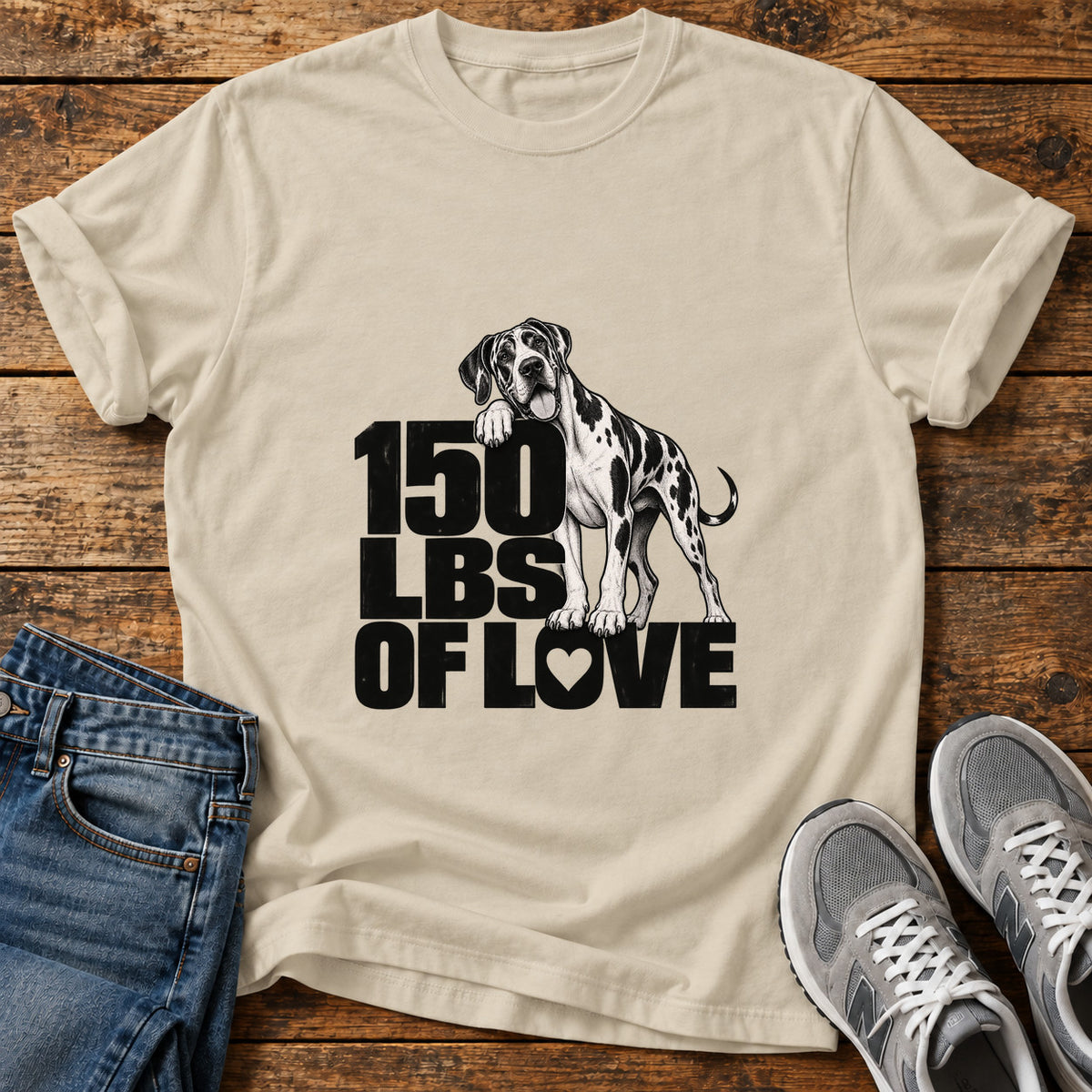 150 Lbs Love Great Dane graphic T-shirt in Sand, shown on a flat-lay shirt mockup